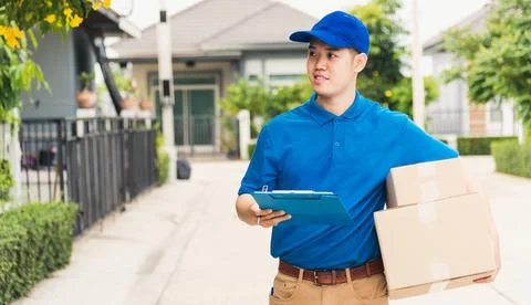 Delivery man courier in uniform hold parcel post boxes service shipment and w Stock Photos