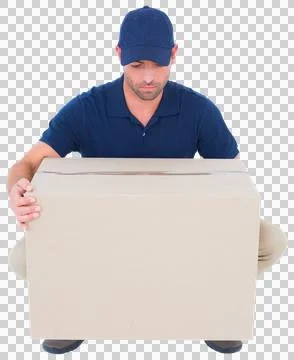 Delivery man crouching while picking cardboard box Stock Photos