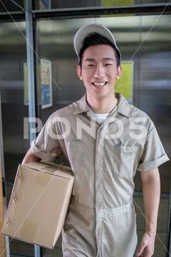 Delivery Man Delivering Package To Homeowner
