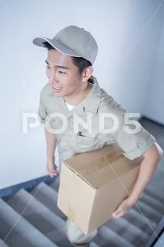 Delivery Man Delivering Package To Homeowner