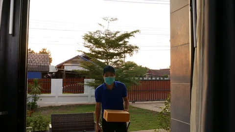 Delivery man delivering a parcel box to customer woman at home Stock Footage 130120722