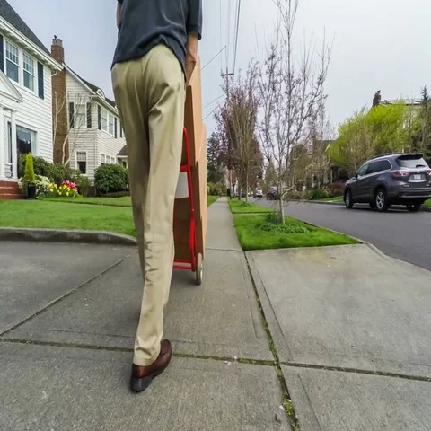 Delivery man dropping off boxes on doorstep Stock Footage 69473857