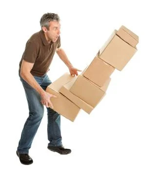 Delivery man with falling stack of boxes 스톡 사진