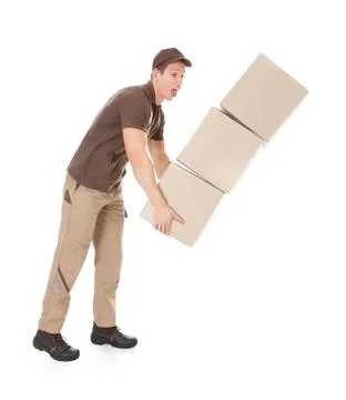 Delivery man with falling stack of boxes Stock Photos
