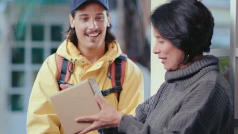 Delivery Man Giving Parcel Box to Mature Woman 動画素材 253752373