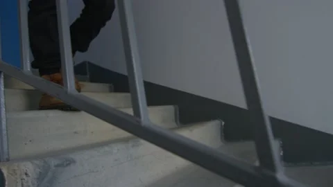 The delivery man goes down the stairs Stock Footage 236898795