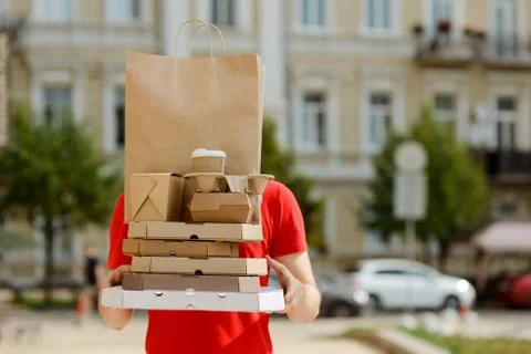 Delivery man with hands full of boxes Stock Photos
