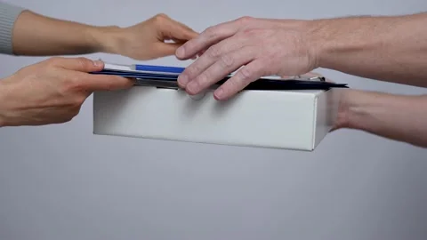 Delivery man hands giving package to female hands Stock Footage 239137835