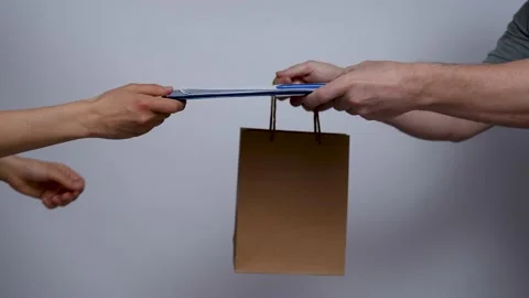 Delivery man hands giving package to female hands Stock Footage 239137913