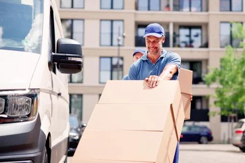 Delivery Man With Handtruck Stock Photos