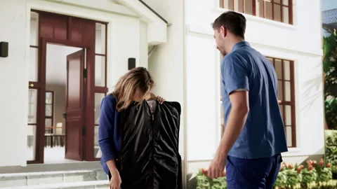 Delivery Man Happily Hands Over Clean Coat During Commercial Laundry Stock Footage 332907568
