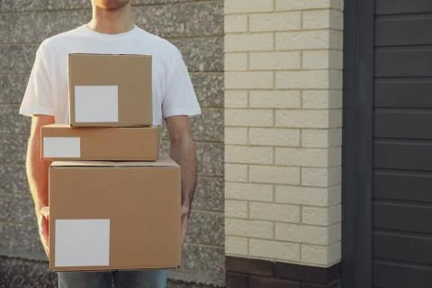 Delivery man hold blank boxes outdoor, space for text 写真素材