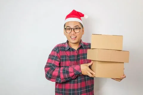 Delivery man holding boxes during Christmas. Isolated on a White Background. Stock Photos