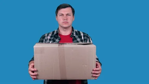 Delivery man holding a parcel box - isolated on blue background. Video stock 147453589