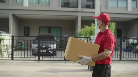 Delivery man holding parcel boxes finding Customer home Village Stock Footage 243070676