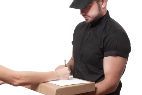 Delivery man holding a parcel while woman putting signature in clipboar.  Cou Fotos Stock