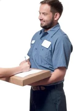 Delivery man holding a parcel while woman putting signature in clipboar.  Cou 写真素材