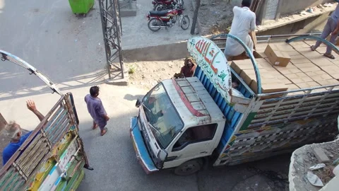 Delivery Man Loads Cardboard Boxes Into Tuck: Lahore, Pakistan 5 Jun 2026 Stock Footage 336812111