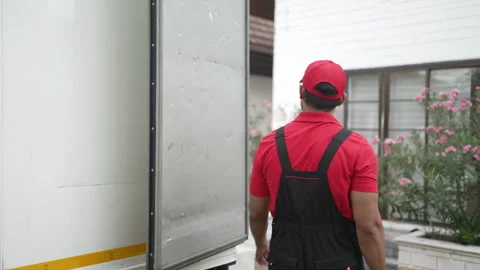 Delivery man move items to the house. Stock Footage 245283781