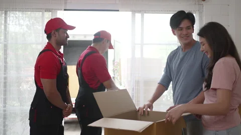 Delivery man move items to the house. Stockbeeldmateriaal 245283785