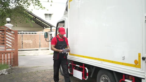 Delivery man move items to the house. Stock Footage 245284039