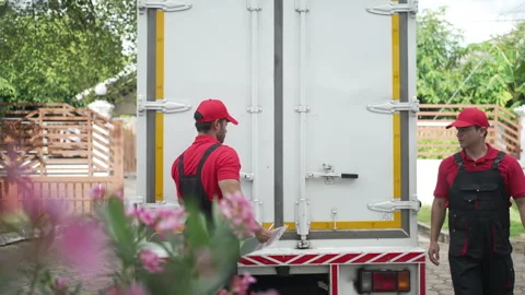 Delivery man move items to the house. Stockbeeldmateriaal 245284067