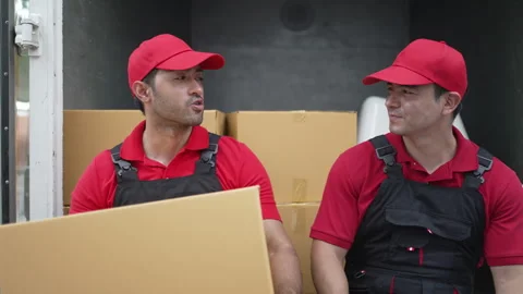 Delivery man move items to the house. Stockbeeldmateriaal 245284097