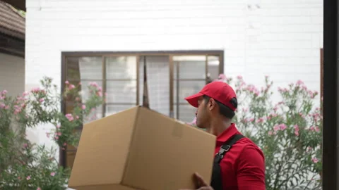 Delivery man move items to the house. Stock Footage 245284205