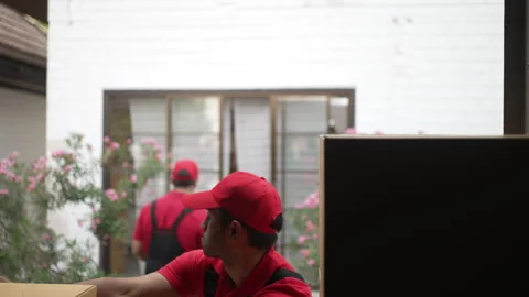 Delivery man move items to the house. Stock Footage 245284241
