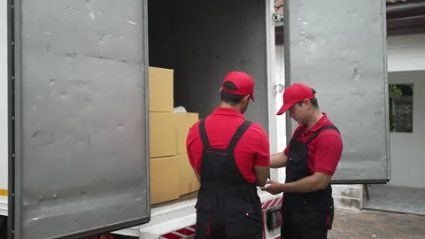 Delivery man move items to the house. 스톡 동영상 245284256