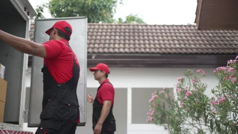Delivery man move items to the house. Stock Footage 245284377