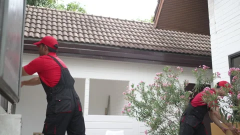 Delivery man move items to the house. Stock Footage 245284391