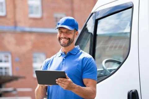Delivery Man Near Truck Or Van Stock Photos