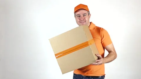 Delivery man in orange uniform throwing a big parcel at the camera. Light gray Stock Footage 67676903
