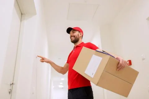 Delivery man with parcel box ringing doorbell Stock Photos