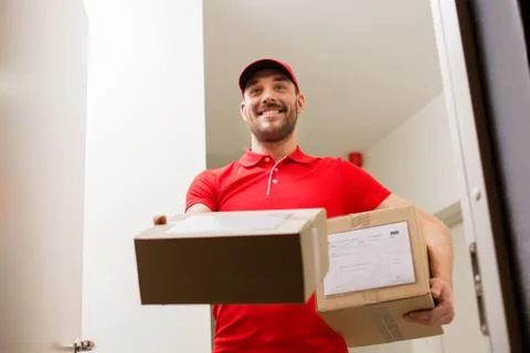 Delivery man with parcel boxes at customer door 写真素材