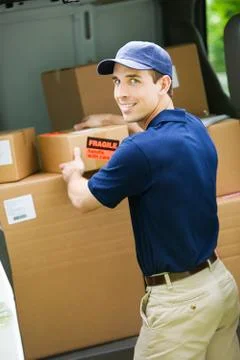 Delivery: man pulling box from delivery van Stock Photos