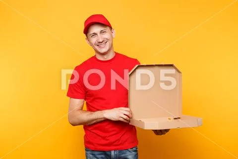 Delivery man in red cap, t-shirt giving food order pizza boxes isolated on Stock Photos