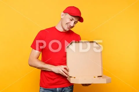 Delivery man in red cap, t-shirt giving food order pizza boxes isolated on Stock Photos