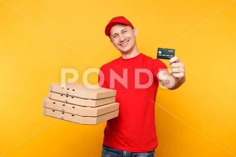 Delivery man in red cap t-shirt giving food order pizza boxes isolated on yellow Stock Photos