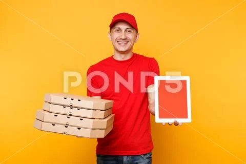 Delivery man in red cap t-shirt giving food order pizza in flatbox boxes on Stock Photos