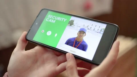 Delivery man ringing door bell on cctv secure camera system on mobile phone app Stock Footage 165808251