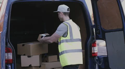 Delivery man scanning boxes with barcode scanner Stock Footage 61768072