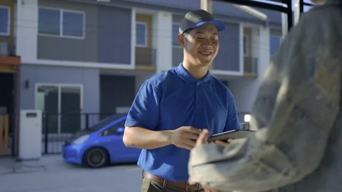 Delivery man sending parcel postal package order comes to customer Stock Footage 123040830