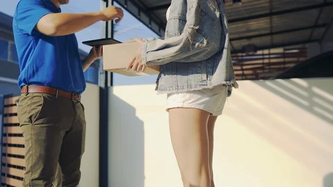 Delivery man sending parcel postal package order comes to customer Stock Footage 123042016