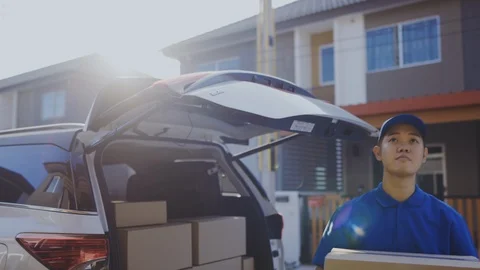 Delivery man take the package from trunk sending parcel postal package Stock Footage 123038302