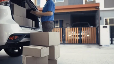 Delivery man take the package from trunk sending parcel postal package Stock Footage 123038473