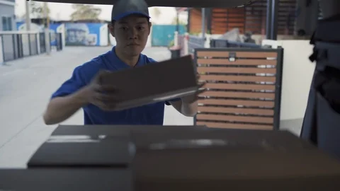 Delivery man take the package from trunk sending parcel postal package Stock-Footage 123042649