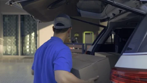Delivery man take the package from trunk sending parcel postal package Видео 128472046
