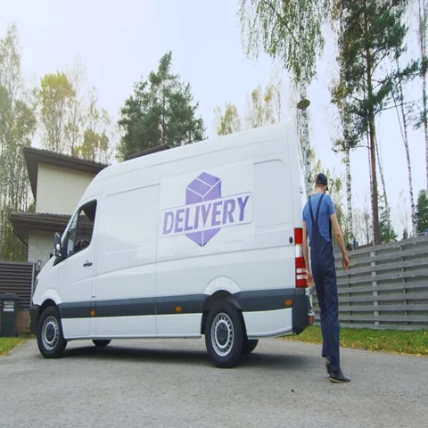 Delivery Man Takes Cardboard Boxes Out of His Cargo Van. In a Suburban Area. Sun Stock Footage